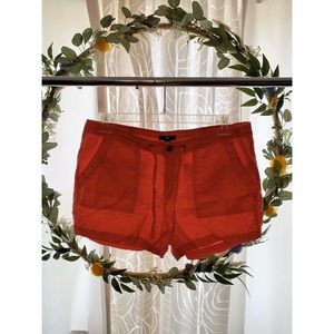 Salmon colored shorts.